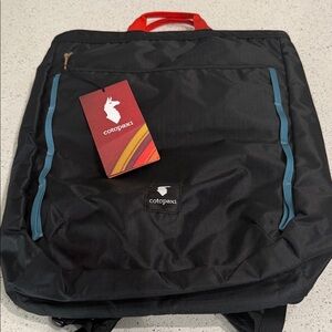 cotopaxi Black Backpack with Red Handle and Blue Trim